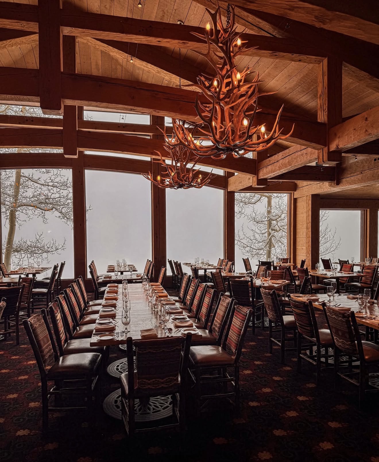 The dining room at Allred's, with antler chandelier and mountain views