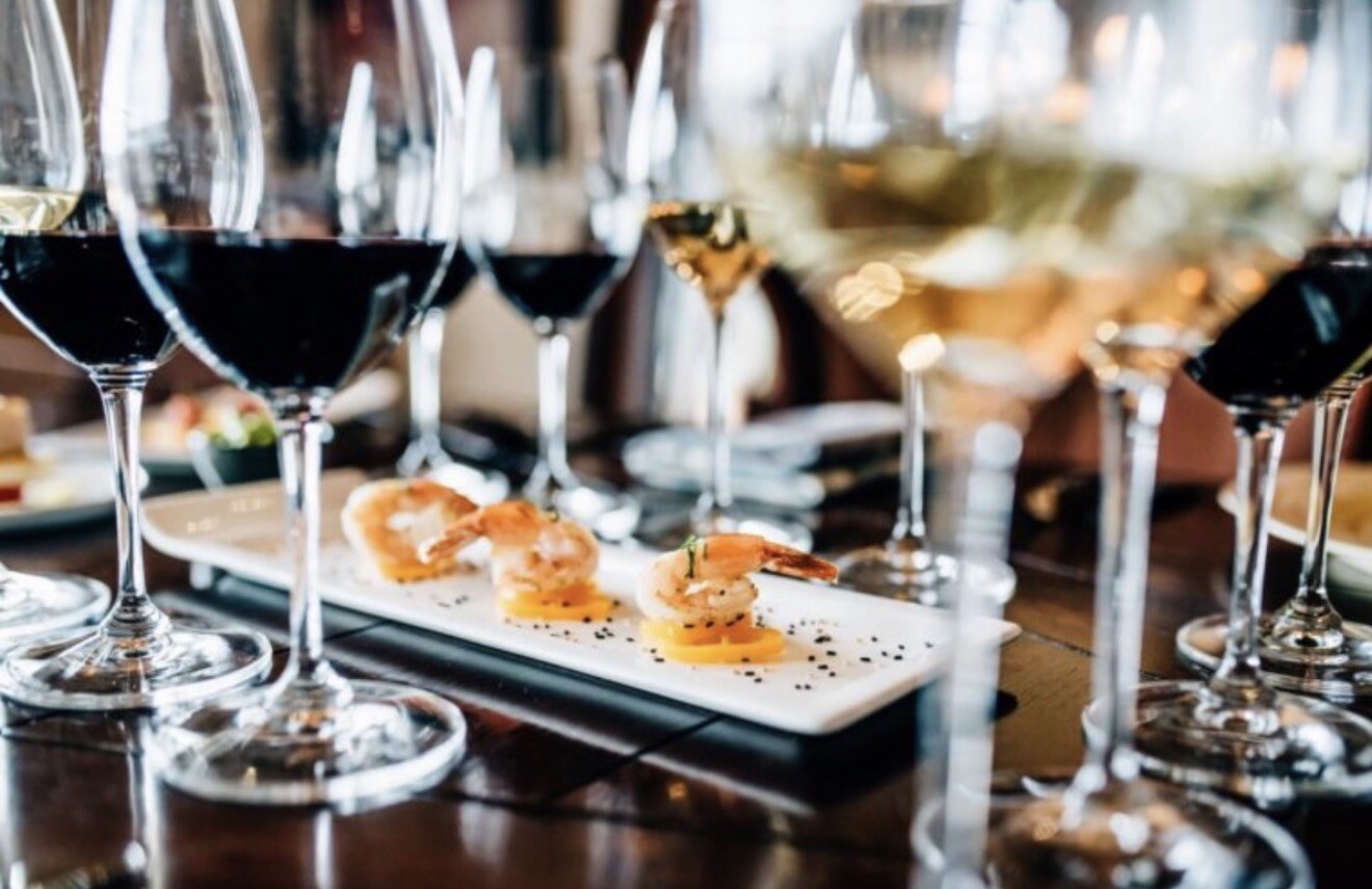 Wine glasses and a shrimp appetizer plated at Allred's